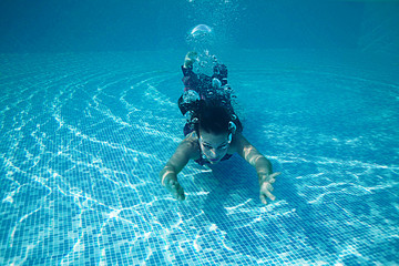 Beautiful woman swiming underwater