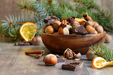 Hazelnuts with chocolate and cinnamon in a wooden bowl.