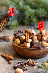 Hazelnuts with chocolate and cinnamon in a wooden bowl.