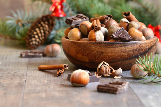 Hazelnuts with chocolate and cinnamon in a wooden bowl.