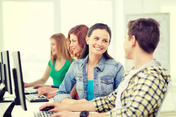 Fototapeta premium smiling students in computer class at school