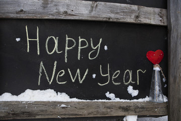 grunge chalk inscription on the board happy new year