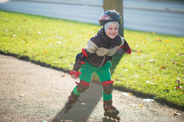 Happy little boy in sunny day on rolle