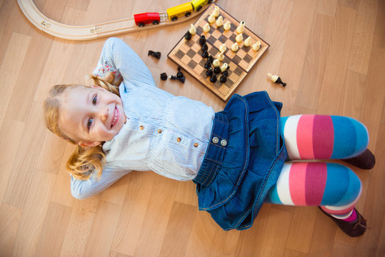 Happy Cute Girl Lying On Floor