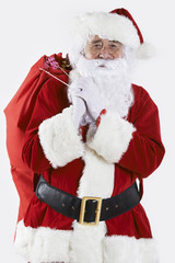 Santa Claus Carrying Sack Filled With Gifts