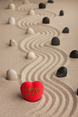 Fototapeta na wymiar One conceptual heart in the sand
