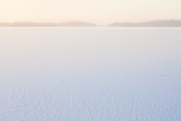 Winter morning view to frozen lake