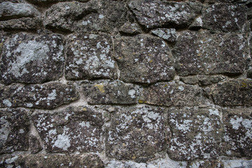 wall of natural stone with lichen