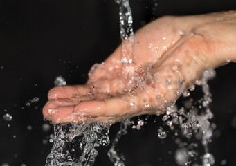 hand in water on a black background