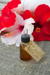 A dropper bottle of hibiscus essential oil.