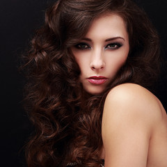 Fototapeta premium Sexy bright makeup female model with brown curly hair