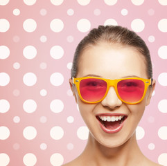 happy laughing teenage girl in pink shades