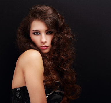 Beautiful makeup woman with curly hairstyle on black background