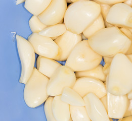 Closeup of peeled cloves of garlic, background