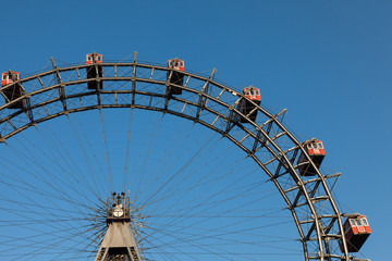Ferris wheel with red cabines in Prater park, Vienna