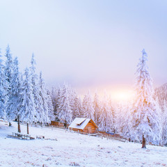 sunset in the winter mountains and fantastic chalet