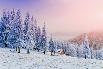Obraz premium sunset in the winter mountains and fantastic chalet