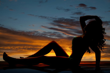 silhouette woman fringe bikini sit back hand on head