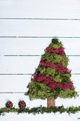 Christmas tree made from moss on white wood
