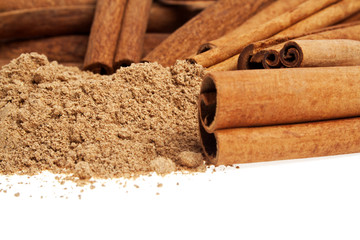 Cinnamon sticks and powder on a white background