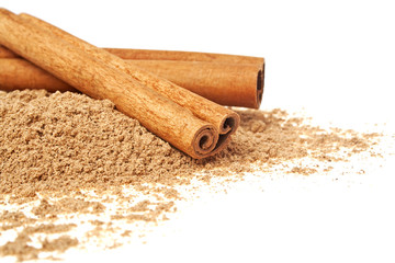 Cinnamon sticks and powder on a white background