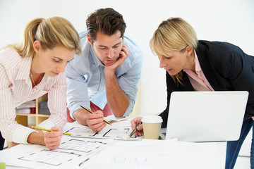 Architects Planning Layout Of Empty Office Space