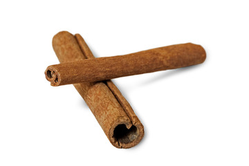 Closeup of two Indonesian cinnamon sticks, isolated on white