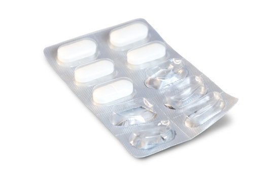 Closeup of white medicine pills in a partly used blister pack
