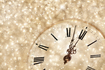 Fototapeta na wymiar Old clock with stars snowflakes and holiday lights