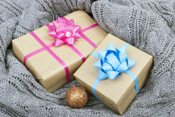 Fototapeta na wymiar Christmas presents on a gray knitted background