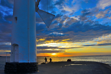 Lighthouse on a cliff at sunset