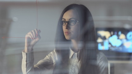 The scientist draw at the virtual screen in the modern office