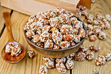 Peanuts in caramel with sesame on board