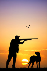 Fototapeta na wymiar hunter with dog at sunset