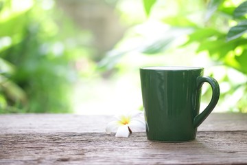 coffee in green cup on wooden table