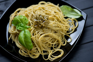 Spaghetti served with pesto sauce, close-up, studio shot
