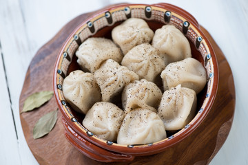 Close-up of boiled georgian khinkali served with black pepper