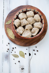 Ceramic dish with boiled khinkali, view from above