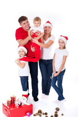 Happy cute family in santa's hats - 73916802