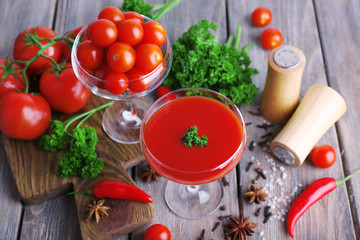Tomato juice in goblet and fresh vegetables