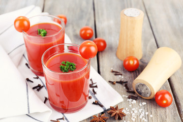 Tomato juice in glasses and fresh vegetables