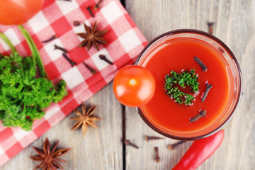 Tomato juice in glass and fresh vegetables