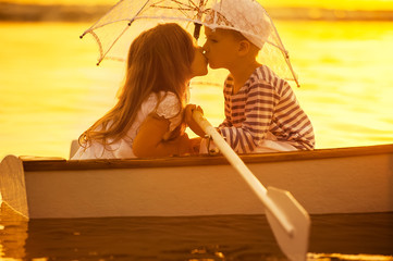 Boy kiss a girl, boating rowed across the lake
