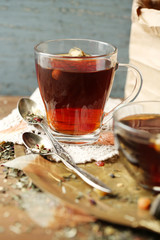 Beautiful vintage composition with herbal tea, on wooden table