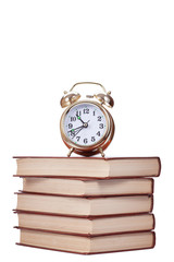 Naklejka premium Gold alarm clock stand on a pile of books