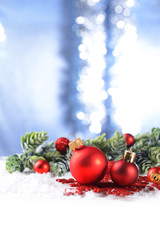 Christmas composition with baubles and fir-tree on snow