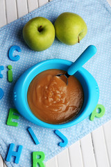 Fresh baby food in bowl with spoon