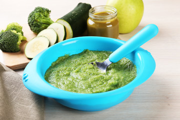 Fresh baby food in bowl with spoon