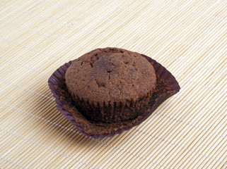 Chocolate muffin on a light background of bamboo