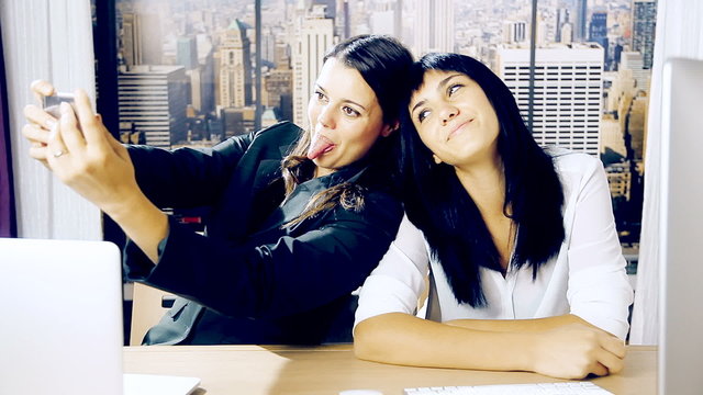 Business women having fun doing selfie in office